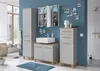 A modern bathroom with blue walls, featuring a vanity with a sink, a tall cabinet, and a drawer unit. The scene includes decorative elements like photos on the wall and a bust sculpture. Produktbild-Vorschau