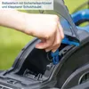 A hand is shown inserting a blue key into a battery compartment of a lawnmower. Podgląd zdjęcia produktu