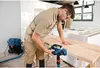 A man is using a planer tool on a wooden surface in what appears to be a workshop or kitchen renovation setting. Anteprima dell’immagine prodotto