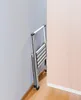 A folded aluminum step stool is leaning against a wall in a corner, next to a door. Náhled obrázku produktu