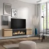 A modern living room with a wall-mounted TV stand featuring an electric fireplace, artwork, and a floor lamp. Produktbild-Vorschau