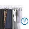 Clothing items hanging on hangers on a rack. Produktbild-Vorschau