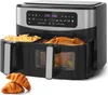 A dual-zone air fryer with food inside, placed on a white background with croissants in the foreground. Produktbild-Vorschau