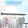 A wall-mounted clothes drying rack with clothes hanging on it, set against a sky background. Produktbild-Vorschau