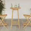 A bamboo bar table with two chairs set up on an outdoor patio. Anteprima dell’immagine prodotto