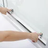 A close-up view of a person's hands interacting with a shower enclosure's sliding mechanism. Produktbild-Vorschau