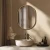 A bathroom vanity with a sink, faucet, mirror, and decorative items. Náhled obrázku produktu