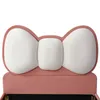 A close-up view of a pink upholstered bed frame with a white bow-shaped headboard. Anteprima dell’immagine prodotto