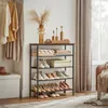 A shoe rack displaying shoes and folded linens in a room setting with clothing hanging on the left and curtains on the right. Náhled obrázku produktu
