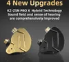 Two in-ear headphones, one gold and one black, are displayed against a dark gray background. Text above highlights "4 New Upgrades" and mentions "KZ-ZSN PRO X Hybrid Technology" with improved sound field and hearing sense. Podgląd zdjęcia produktu