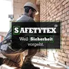 A construction worker wearing safety gear is kneeling next to a brick wall. Produktbild-Vorschau