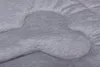A close-up view of a quilted gray dog bed with a bone-shaped pattern. Produktbild-Vorschau