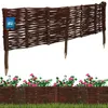 A woven willow border fence with pointed stakes, shown both freestanding and in a garden setting with flowers and grass. Náhled obrázku produktu