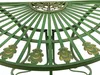 A close-up view of the decorative metalwork on a green table, featuring ornate gold accents. Náhled obrázku produktu
