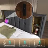 A bed with a headboard featuring integrated storage and charging options. Náhled obrázku produktu