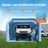 A man is working on a white van inside an inflatable spray booth. Voir les images du produit