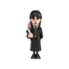 A figurine of Wednesday Addams holding books, with Thing's hand on her shoulder. Podgląd zdjęcia produktu
