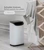 A white dehumidifier is shown next to a wooden drying rack with clothes on it, in a room with white walls and light wood flooring. Text overlays highlight the product's features. Anteprima dell’immagine prodotto
