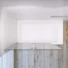A top-down view of a bathtub with a glass shower screen in a modern bathroom. Produktbild-Vorschau