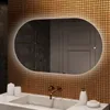 A bathroom vanity with a sink, faucet, and an illuminated oval mirror mounted on a tiled wall. Produktbild-Vorschau