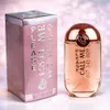 A perfume bottle and its box are displayed side-by-side on a sparkly pink and white background. Anteprima dell’immagine prodotto