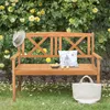 A wooden garden bench sits in front of a rose bush with yellow flowers. Voir les images du produit