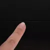 A finger is pressing a button on a black surface. Náhľad obrázku produktu