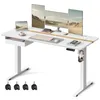 A white electric standing desk with multiple monitors, a laptop, keyboard, mouse, and headphones. Produktbild-Vorschau