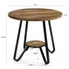 A round wooden table with black metal legs and a lower shelf, shown with dimensions indicated. Produktbild-Vorschau