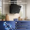 A modern kitchen scene with a black range hood as the focal point, complemented by kitchenware and a decorative plant. The lower part of the image features a close-up of a motor with overlaid text highlighting product features. Voir les images du produit