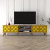 A TV stand with a television on top, placed in a room with white paneled walls and a wooden floor. Náhled obrázku produktu