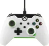 A white Xbox controller with green accents is shown against a white background. Voir les images du produit