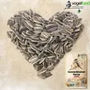 A heart shape made of sunflower seeds with a bag of sunflower seeds and a logo in the corner. Produktbild-Vorschau