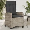 A grey poly rattan garden chair with cushions is placed on a patio next to a small table with a cup. Produktbild-Vorschau