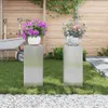 Two plant stands with potted plants in a garden setting. Náhled obrázku produktu