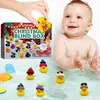 A baby is in a bathtub with several rubber ducks, and an advent calendar box is in the background. Produktbild-Vorschau