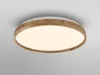 A close-up, front-facing view of a round, white LED ceiling light with a wooden trim, mounted on a light gray ceiling. Produktbild-Vorschau