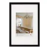 A framed picture of a dining room with a long wooden table and chandelier. Produktbild-Vorschau