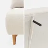 A collage of two close-up images of a cream-colored sofa with bouclé fabric. The left image shows the base and legs of the sofa, while the right image shows a detail of a black handle protruding from the side. Produktbild-Vorschau