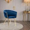 A blue velvet chair with gold legs is placed on a white rug in a room with ornate decor. Náhled obrázku produktu