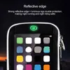 A close-up of a black phone pouch with a reflective edge and a glowing green logo, displaying a smartphone screen with app icons. Produktbild-Vorschau
