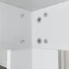 Close-up view of the corner joint of a white furniture piece, showing screws and metal connectors. Produktbild-Vorschau