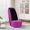 A high-heeled shoe-shaped chair in a room with a cabinet and a small table. Náhled obrázku produktu