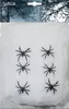 A package of white artificial spiderwebs with black plastic spiders for Halloween decoration. Produktbild-Vorschau