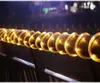 A string of solar-powered LED lights wrapped around a railing at night. Produktbild-Vorschau