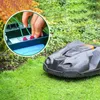 A close-up of a robotic lawnmower on a lawn, with an inset showing a hand connecting wires to a charging station. Produktbild-Vorschau