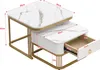 A set of two nesting coffee tables with marble-look tops and gold metal frames. One table has an open drawer showing its interior. Voir les images du produit
