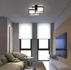 A modern living room with a sofa, coffee table, television, and a ceiling light. Produktbild-Vorschau