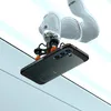 A robotic arm holding a green smartphone case. Podgląd zdjęcia produktu