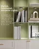 A bookshelf with books and decorative items, illuminated by puck lights. Produktbild-Vorschau